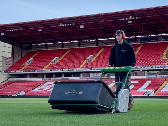 Kieran Morley cutting grass at Barnsley Football Club.