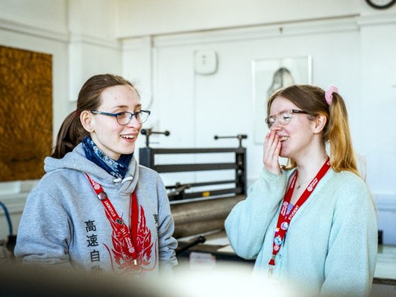 two students smiling at each other