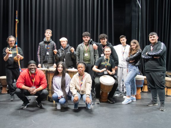 Group of students with African performance group