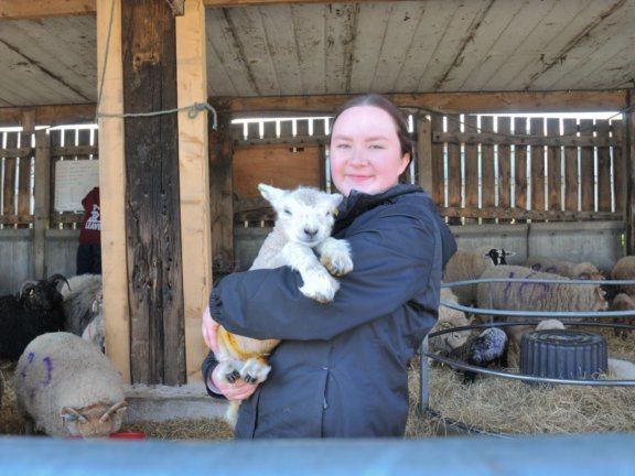 Higher Education student Eliza with Dolly the lamb