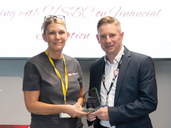 Photo of Julie Ashcroft of HSBC presenting a Smart Money Award to Neil Johnson, our Assistant Principal for Young People.