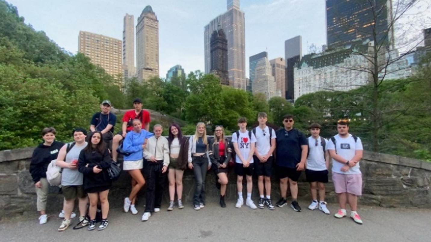 Travel and Tourism and Public Services students in front of New York skyline.