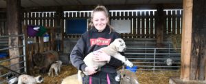 Agriculture student Emily Hanson with one of the farms lambs