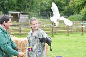 two people and an eagle owl falcon flying 