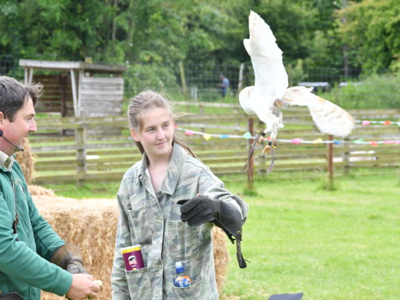 two people and an eagle owl falcon flying