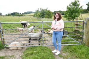 Emily Smith with some of the sheep at Wigfield Farm.