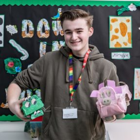 student with paper mache pig and crocodile