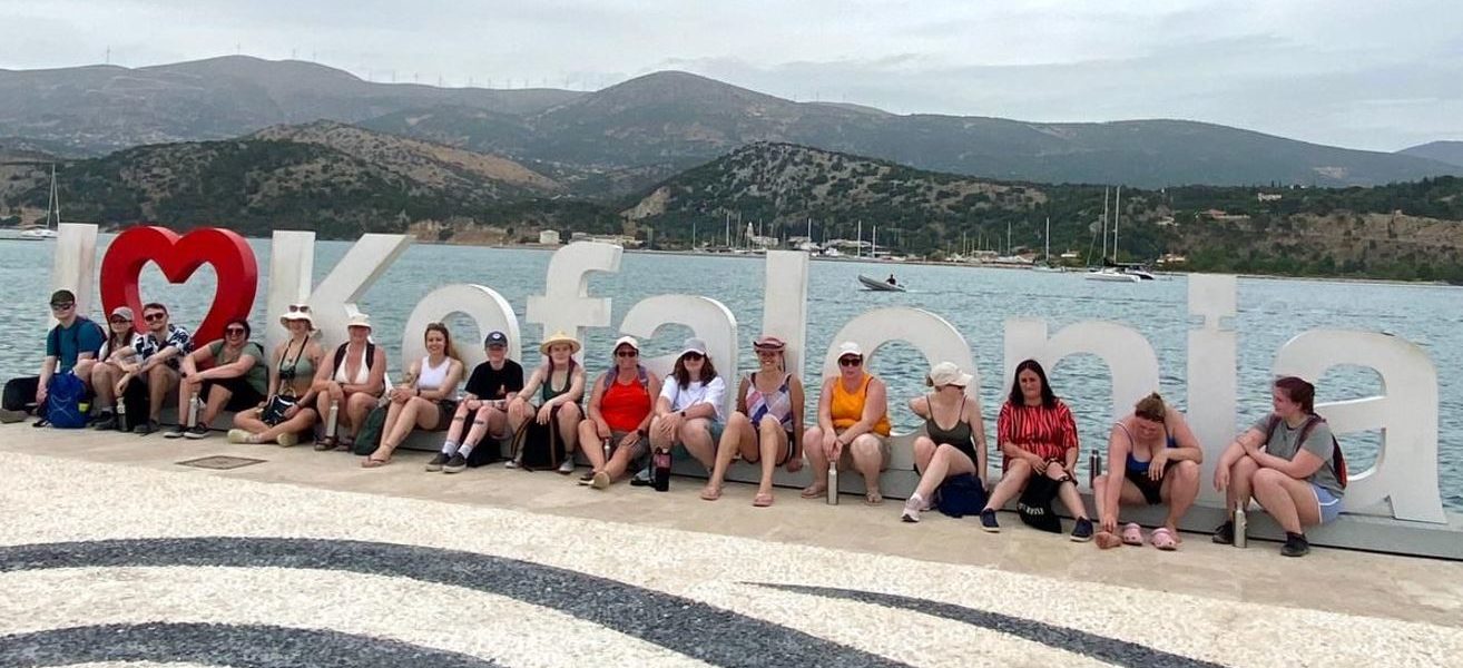 Staff and students in front of the I Love Kefalonia sign in Argostoli