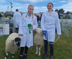 Ashleigh Braisby (left) with her fourth-place rosette and Millie Taylor (right) with her second-place rosette. 