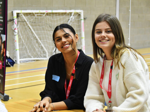 Business students smiling at Employer networking event