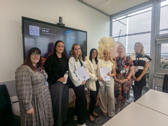 Abigail Bates (centre) with the other three alumni alongside Barnsley Council Social Worker and College staff