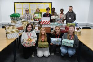 Level 3 Health and Social Care students with their mountain of shoeboxes.