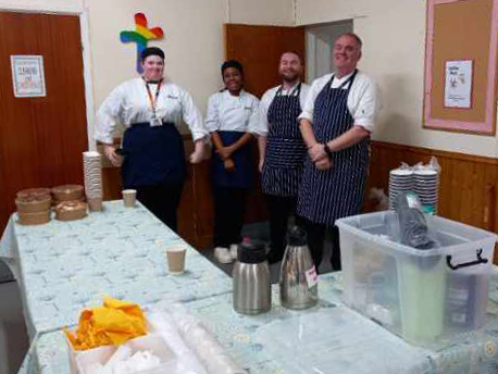 Staff and students looking at the camera, smiling.